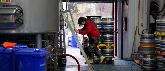 A brewer climbing at ladder at Five Points' Hackney brewery