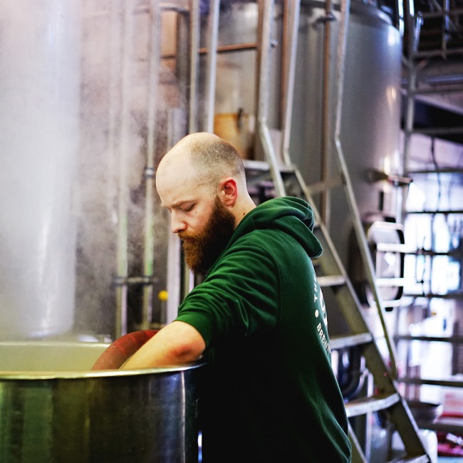 A brewer working at The Five Points Brewing Company in Hackney, London
