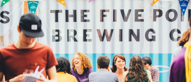 A table of people laughing and drinking outside The Five Points Brewing Company in Hackney
