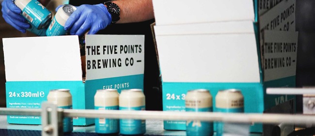 Brewery staff packaging cans of Five Points XPA into cases